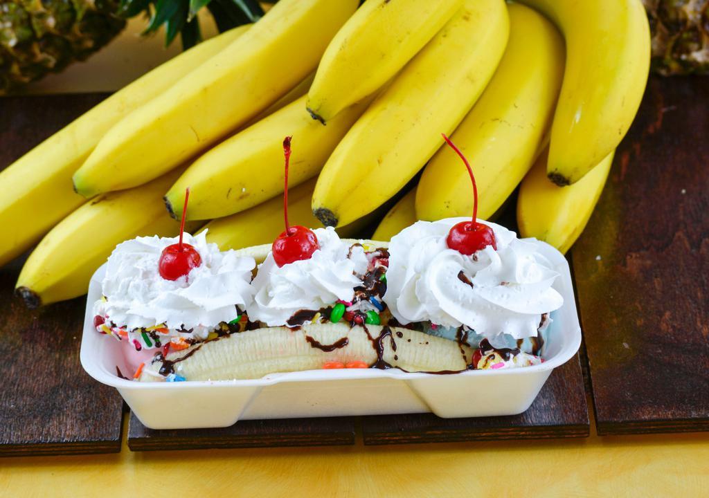 Banana Split · A split banana covered with three scoops of ice cream, topped with fudge drizzle, whipped cream, cherries, sprinkles, and peanuts.
