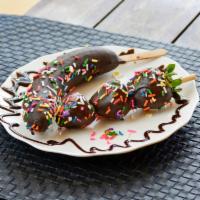 Chobanana · A banana dipped in chocolate, topped with sprinkles.
