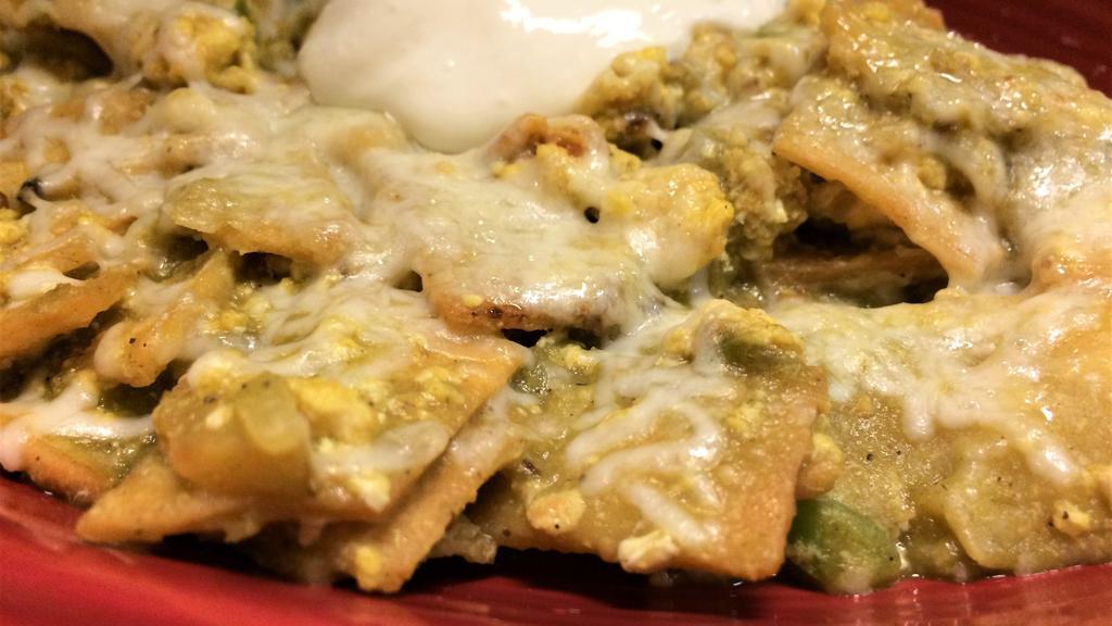 Chilaquiles Rojos or Verdes · Two large eggs scrambled with tortillas mixed with onions, bell pepper & tomatoes your choice of red or green sauce & cheese served with rice & beans (green chilaquiles topped with sour cream).