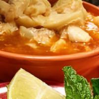 Menudo · Beef tripe soup with side of chopped onions, green pepper and lime.