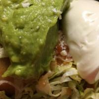 Chimichanga · Deep fry burrito topped with lettuce, sour cream and guacamole.