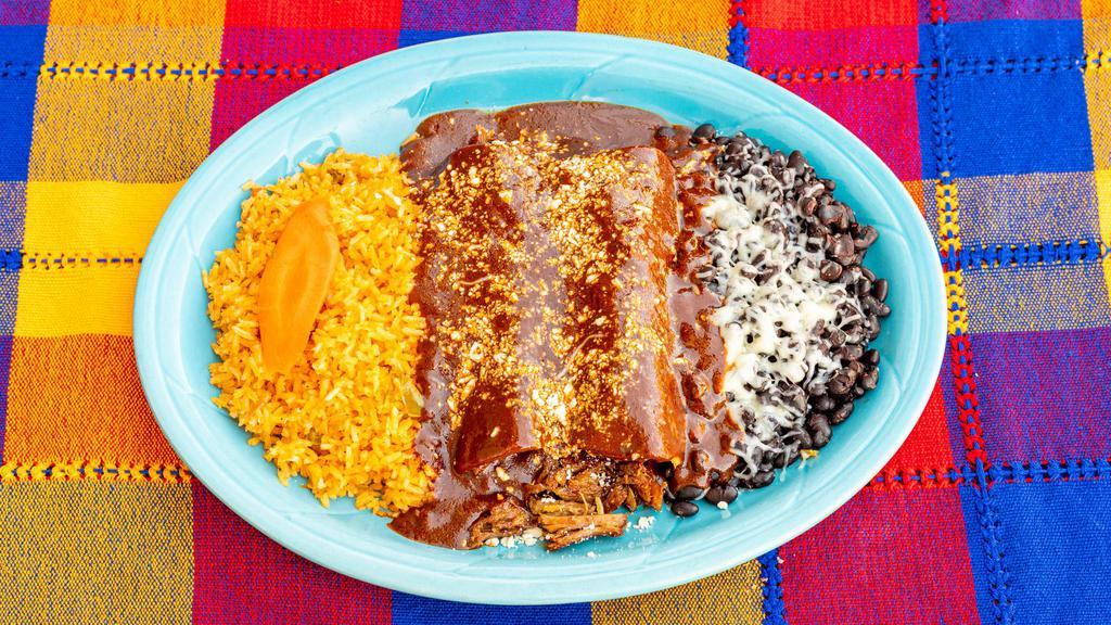 23. Mole Enchiladas · Topped with dry cotija cheese.