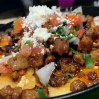 Chorizo Bean Dip · Refried beans topped with grilled chorizo, melted cheese and pico de gallo.
