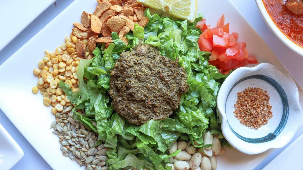 Tea Leaf Salad · Vegetarian, vegan, gluten-free. Burmese fermented tea leaves serves with your choice of lettuce or cabbage, tomatoes, jalapeños, peanuts, garlic chips, fried yellow beans, sesame seeds, sunflower seeds and dried shrimp powder.