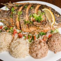Mojarra · Whole bone in tilapia seasoned and deep fried served with white rice and beans