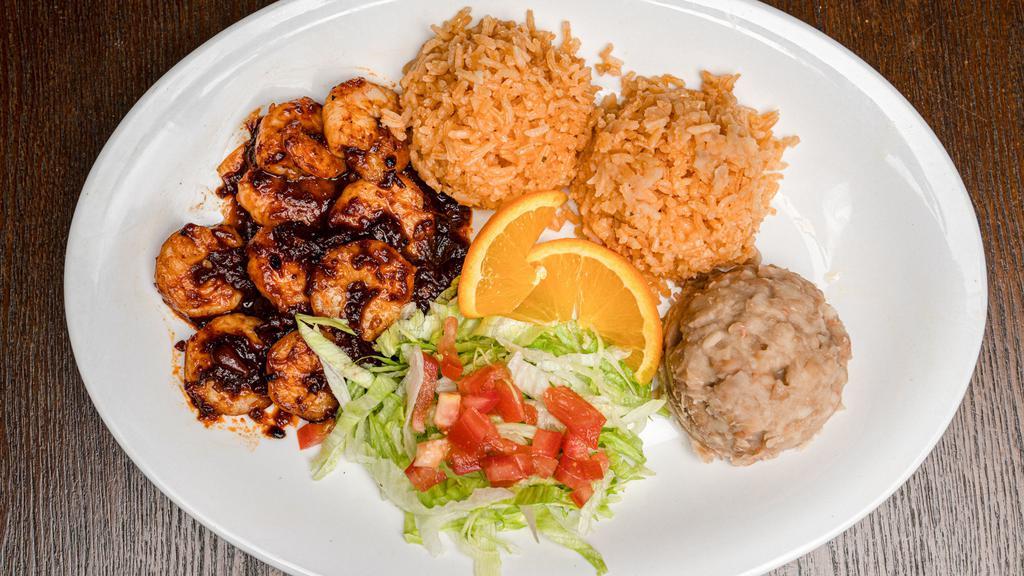Camarones ala diabla · Shrimp sautéed in our house chipotle sauce served with rice beans and tortillas