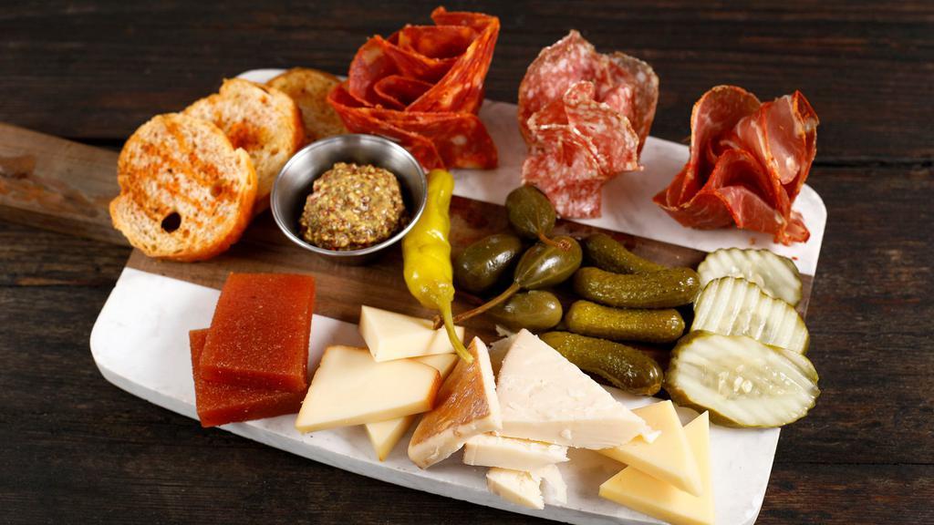 Charcuterie & Cheese Board · Artisanal meats and cheeses with good things that go with both.