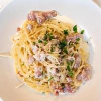 SPAGHETTI CARBONARA · Spaghetti pasta, pancetta, egg yolk, cream, parmesan cheese and black pepper.