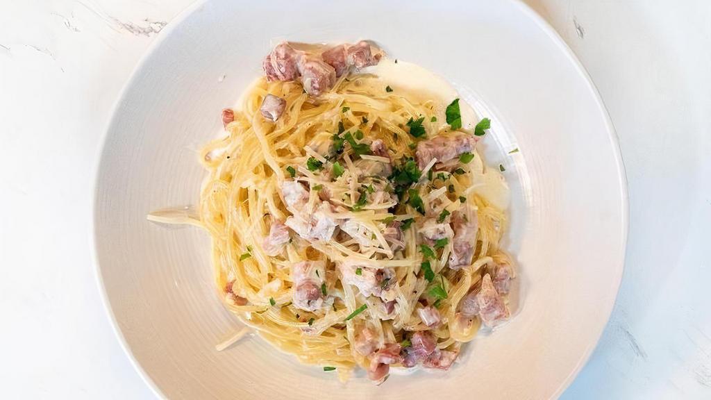 SPAGHETTI CARBONARA · Spaghetti pasta, pancetta, egg yolk, cream, parmesan cheese and black pepper.