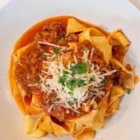 PAPPARDELLE BOLOGNESE · Pappardelle pasta, ground beef, tomato sauce, parmesan cheese and fresh basil.