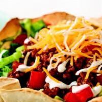 Taco Salad · Romaine lettuce, tortilla shell, choice of meat, jack cheese, cilantro lime dressing, tomato...
