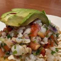 Ceviche Tostada · Shrimp, fresh lime juice, avocado slice, tomatoes, onions, cucumber, jalapeños, cilantro, ma...