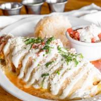 Chile Relleno · Roasted pasilla pepper filled with vegetables and choice of meat, wrapped in egg and topped ...