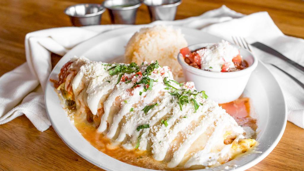 Chile Relleno · Roasted pasilla pepper filled with vegetables and choice of meat, wrapped in egg and topped with ranchera salsa, melted cheese, and sour cream. Served with rice and beans.