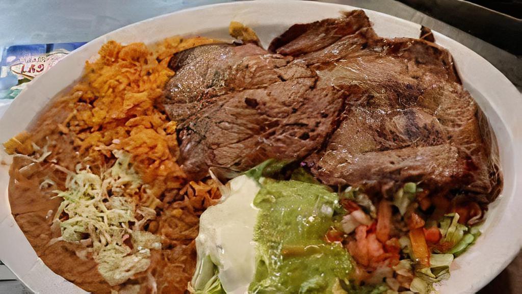 Asada Platter · Steak (certified angus beef), caramelized onions, salsa ranchera. Served with rice, beans, and side of tortillas.