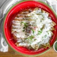 Chilaquiles Rojos, Verdes or Mole · Served with two fried eggs, tortillas chips, sour cream, and cheese.