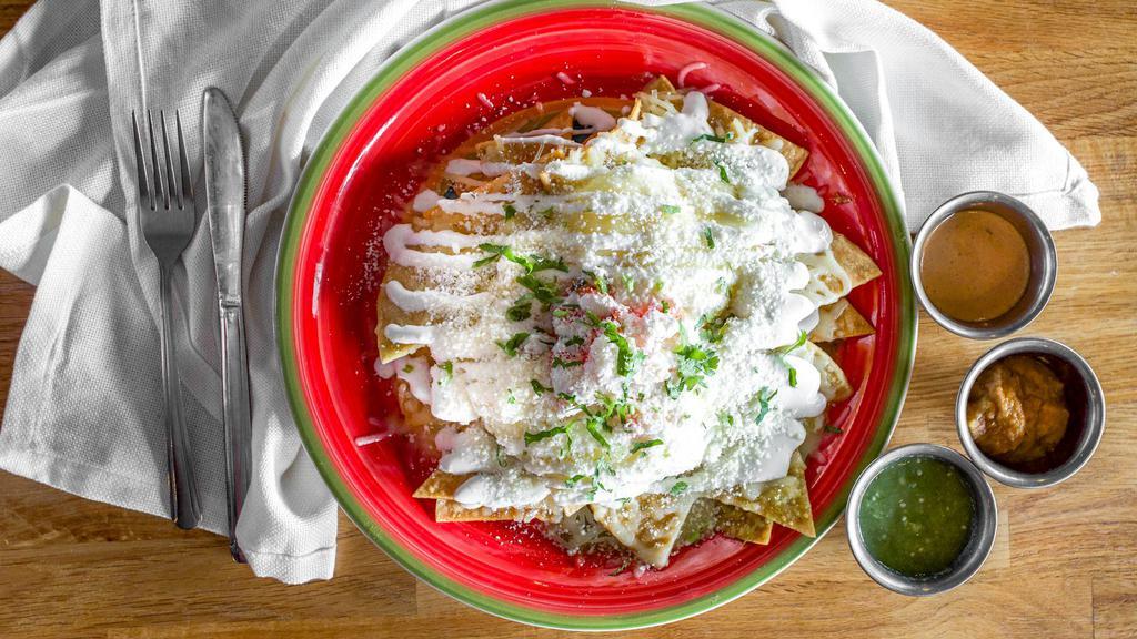 Chilaquiles Rojos, Verdes or Mole · Served with two fried eggs, tortillas chips, sour cream, and cheese.