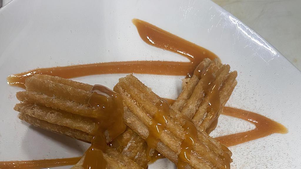 Churros  · House made with dulce de leche.