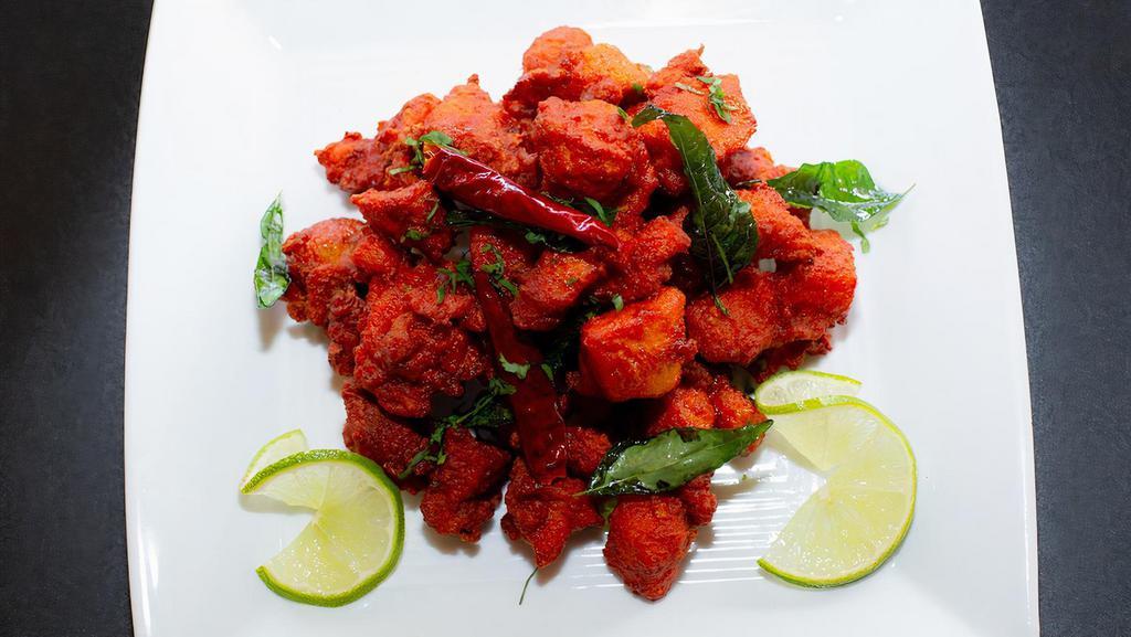 Chicken 65 · Slightly battered boneless chicken cubes tossed in yogurt sauce flavored with spices and curry leaves