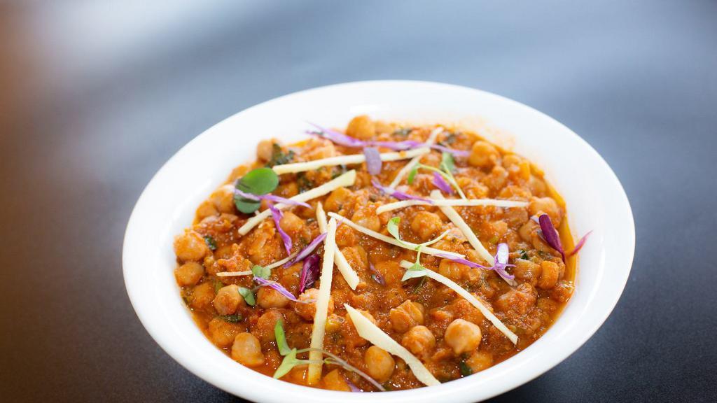 Chana Masala Curry · Garbanzo Beans cooked with finely chopped tomatoes and onions with Indian spices