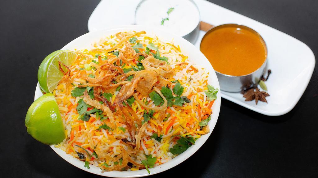 Veg Biryani · Fresh cut vegetables marinated with special spices tossed in curry sauce flavored with spices and mixed with flavored basmati rice. Served with raita and salan.