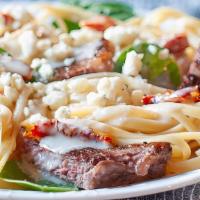 Steak Alfredo · Grilled Steak on Fettuccini Pasta with fresh house made Alfredo sauce and Broccoli.  Served ...