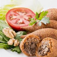 Kubbeh · Three pieces. A mixture of bulgur wheat, onions, and ground beef forms a hollow shell for a ...