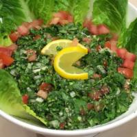 Tabouleh · Chopped parsley, lemon, tomatoes, green onion, bulgur and olive oil.