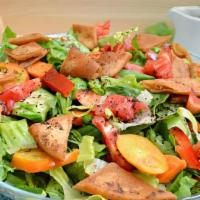 Fattoush Salad · Mixed lettuce, tomato, cucumber, scallions and parsley, topped with baked pieces of bread.
