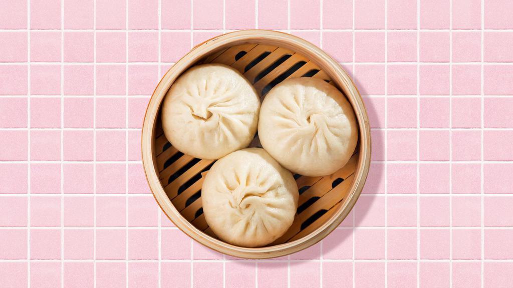 Steamed Buns · Six steamed buns with dipping sauce.