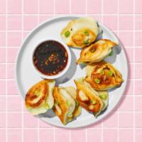 Fried Pork Dumplings · Six fried pork dumplings with dipping sauce.