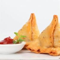 Samosa · Savory pastries filled with peas and spiced potatoes.