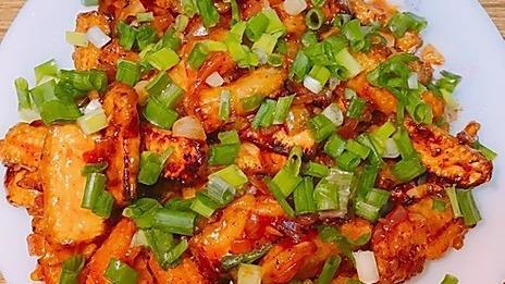 Baby Corn Manchurian · Baby corn deep fried with batter and sautéed bell peppers, manchurian sauce, ketchup, green onions.