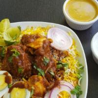Vijayawada Chicken Biryani · Boneless chicken sautéed with our very own special sauce topped with long grain biryani rice.