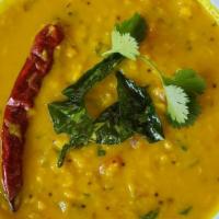 Dal Tadka · Yellow lentils cooked to perfection over fire infused with tempered herbs and select spices.