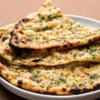 Naan · Soft leavened white bread cooked in clay oven.