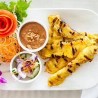 06. Satay · Chicken skewer (5) marinated in herbs spice and yellow curry served with peanut sauce and cu...