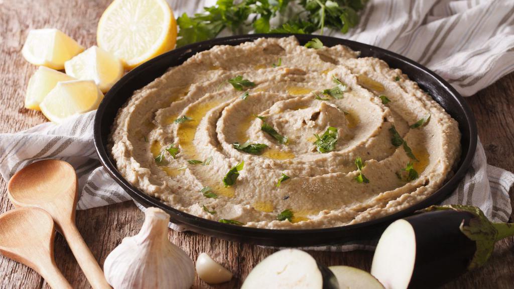 The Baba Ganoush 8oz · Fresh eggplant, olive oil, tahini paste, garlic, lemon juice and salt served with pita bread.