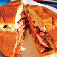 Torta Cubana · Comes with milanesa steak, sausage, and ham. Served with mayonnaise, onion, jalapeño, avocad...