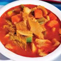 Mondongo · Soup made from diced tripe meat, beef feet, and vegetables. Served with three corn tortillas.