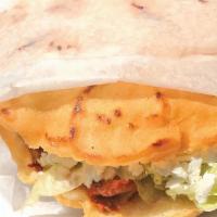 Gordita · Mexican style pita with corn flour stuffed with your choice of meat. Comes with lettuce, oni...