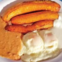 Desayuno Salvadoreño · Salvadorean breakfast that consists of two eggs, sour cream, beans, and fried plantains.
