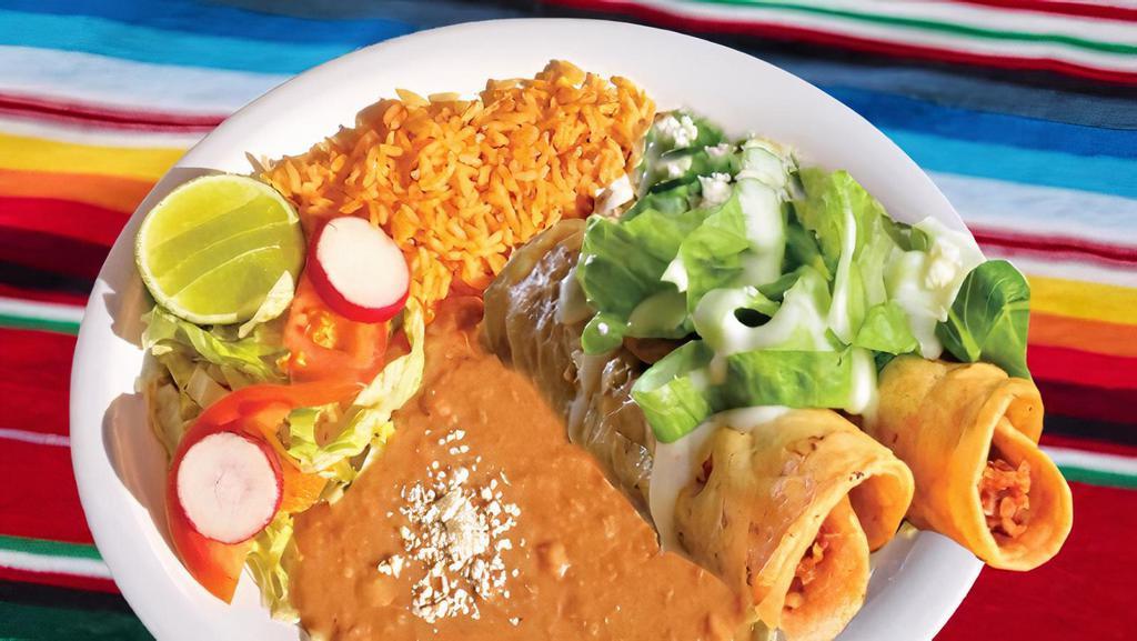 Plato De Flautas · Two fried crispy chicken tacos topped with sour cream and cheese. Served with rice, beans, and salad.
