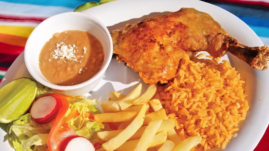 Pollo Dorado · Fried chicken served with rice, beans, french fries, and tortillas.