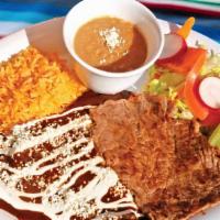 Carne a La Tampiqueña · Two Mexican mole enchiladas topped with sour cream and cheese with a side of steak. Served w...