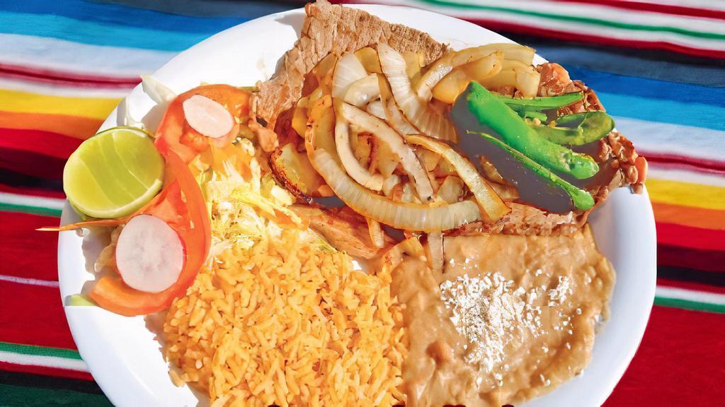 Bistec Encebollado · Steak topped grilled onions. Served with rice, beans, and salad.