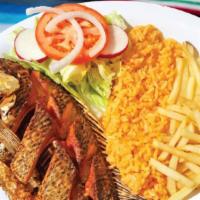 Mojarra Frita · Deep fried tilapia served with rice, salad, and french fries.