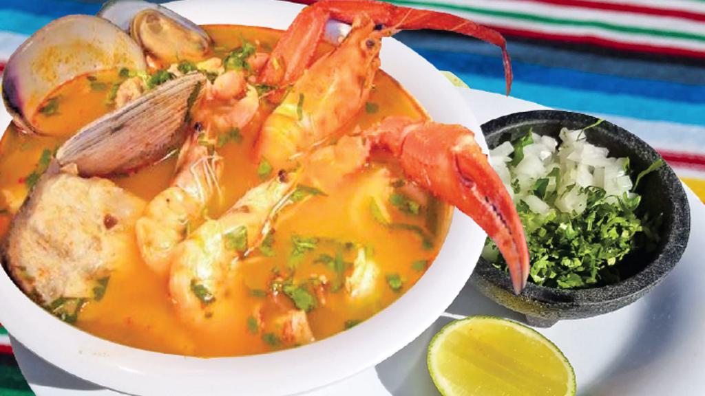 Sopa De Mariscos · Seafood soup with large clams, fish, octopus, and imitation crab. Served with tortillas on the side.