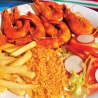 Camarones a La Cucaracha · Shrimp marinated in spicy homemade salsa served with rice, beans, and salad.