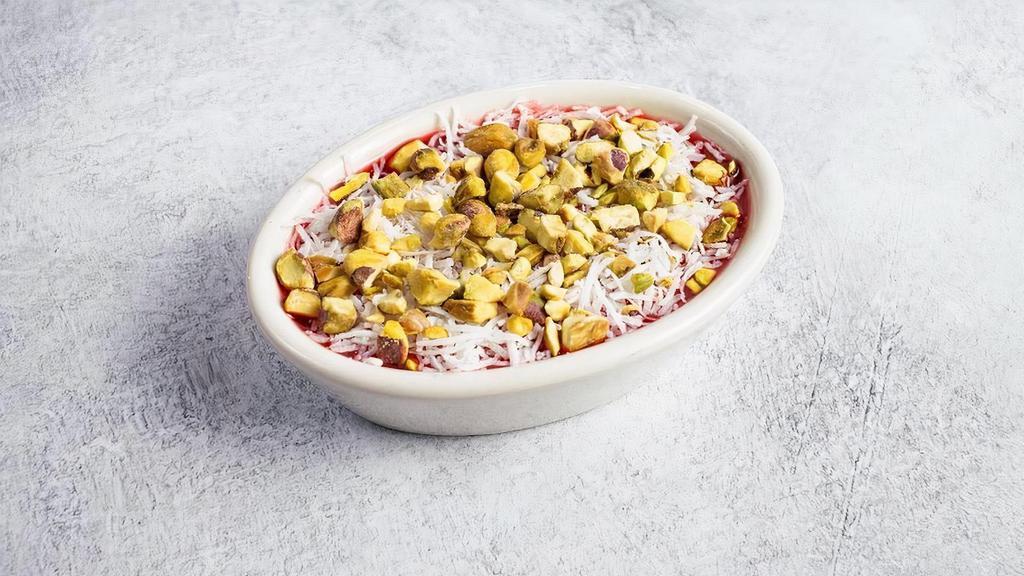 Traditional Malabi · Mediterranean custard topped with coconut, pistachios, rose water, and raspberry syrup (gf)